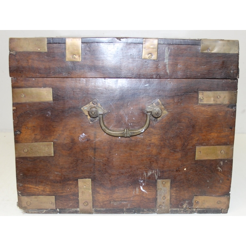 280 - An Anglo-Indian carved hardwood and brass mounted trunk with side carrying handles and fitted interi... 