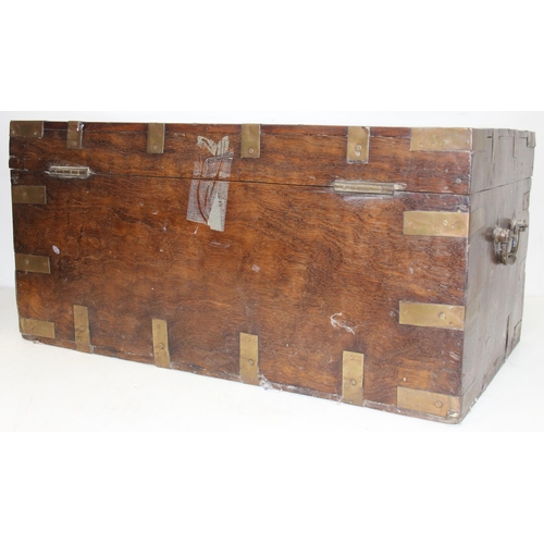 280 - An Anglo-Indian carved hardwood and brass mounted trunk with side carrying handles and fitted interi... 