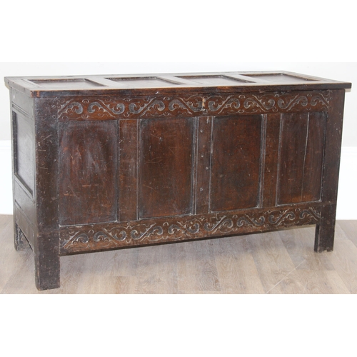 153 - An 18th century oak coffer with carved floral strapwork details, approx 126cm wide x 50cm x 70cm tal... 