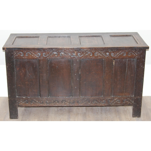 153 - An 18th century oak coffer with carved floral strapwork details, approx 126cm wide x 50cm x 70cm tal... 