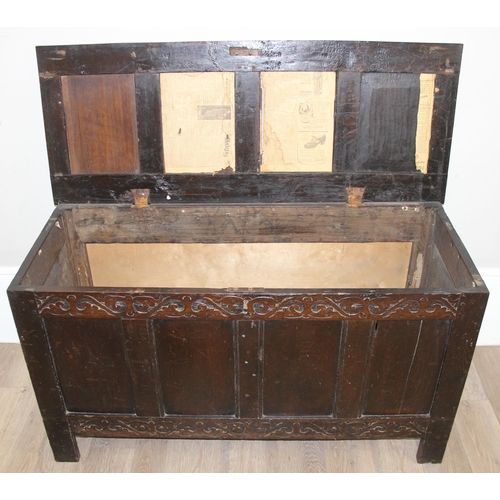 153 - An 18th century oak coffer with carved floral strapwork details, approx 126cm wide x 50cm x 70cm tal... 