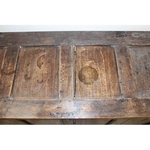 153 - An 18th century oak coffer with carved floral strapwork details, approx 126cm wide x 50cm x 70cm tal... 