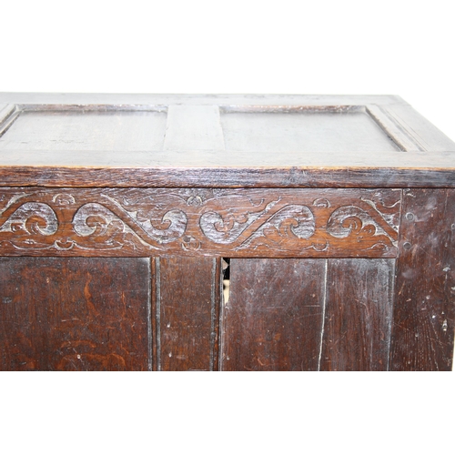 153 - An 18th century oak coffer with carved floral strapwork details, approx 126cm wide x 50cm x 70cm tal... 