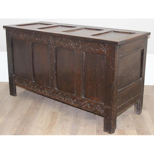 153 - An 18th century oak coffer with carved floral strapwork details, approx 126cm wide x 50cm x 70cm tal... 