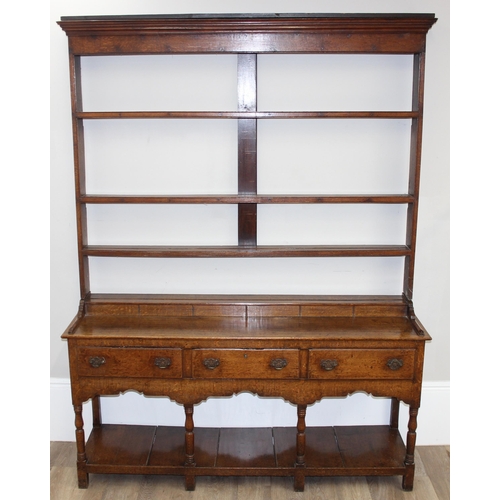 17 - A large antique country oak dresser with plate rack, likely early 19th century, the base set with 3 ... 