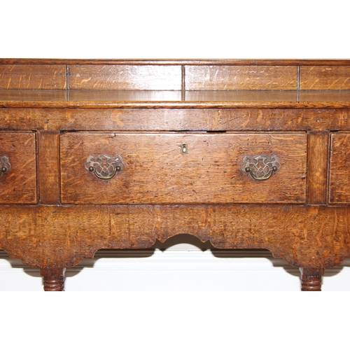 17 - A large antique country oak dresser with plate rack, likely early 19th century, the base set with 3 ... 