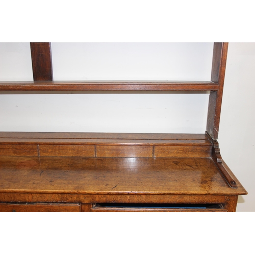 17 - A large antique country oak dresser with plate rack, likely early 19th century, the base set with 3 ... 