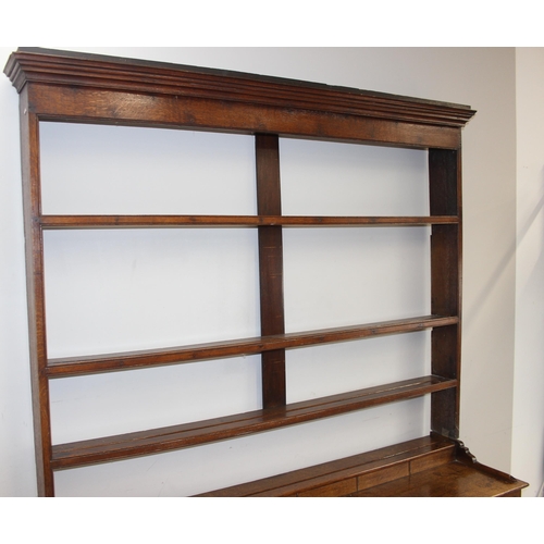 17 - A large antique country oak dresser with plate rack, likely early 19th century, the base set with 3 ... 