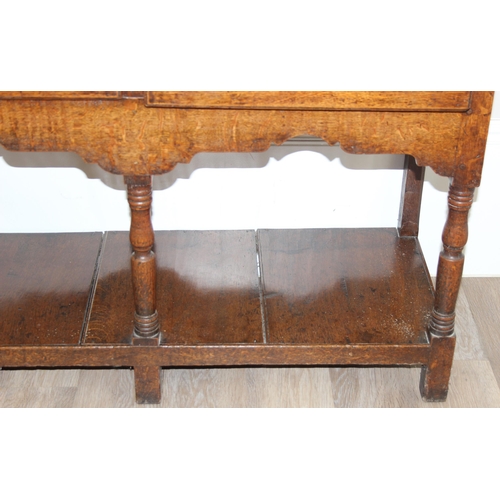 17 - A large antique country oak dresser with plate rack, likely early 19th century, the base set with 3 ... 