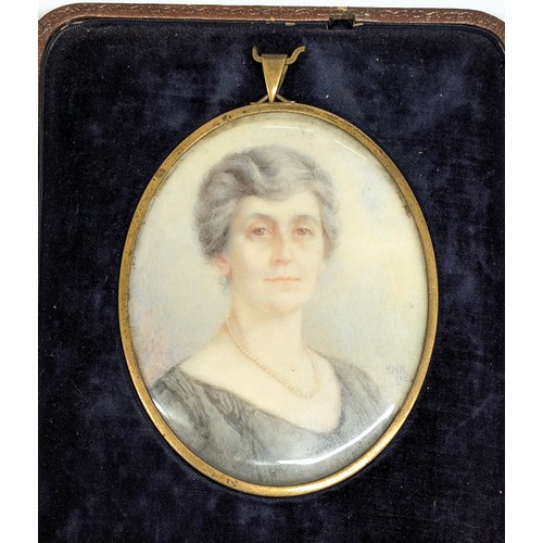 422 - An antique English School portrait miniature of a female with pearl necklace, signed lower right HMK... 