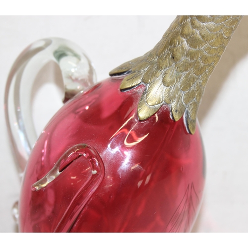 1058 - A rare cranberry glass and silver plate mounted decanter or claret jug formed as a duck, the feet ma... 