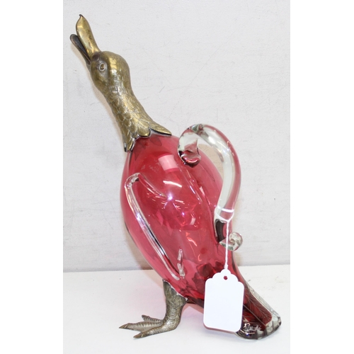 1058 - A rare cranberry glass and silver plate mounted decanter or claret jug formed as a duck, the feet ma... 