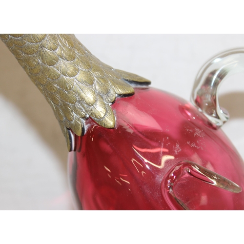 1058 - A rare cranberry glass and silver plate mounted decanter or claret jug formed as a duck, the feet ma... 