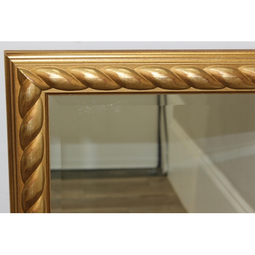 413 - An antique style gilt framed mirror with rope twist style decoration, approx 106cm x 75cm