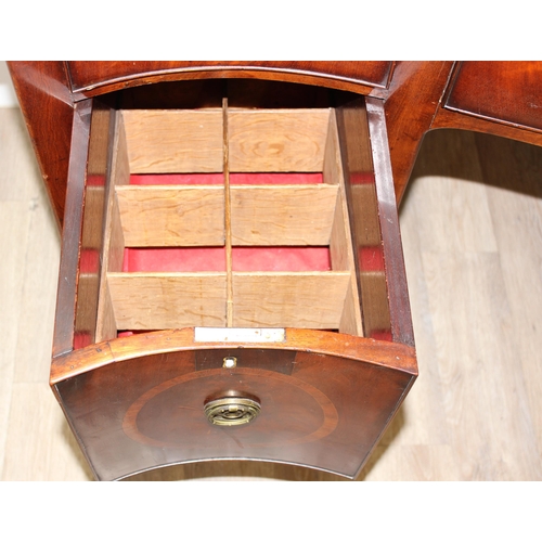 77 - A George III or Regency period mahogany serpentine sideboard, 3 drawers over a fitted cellarette dra... 