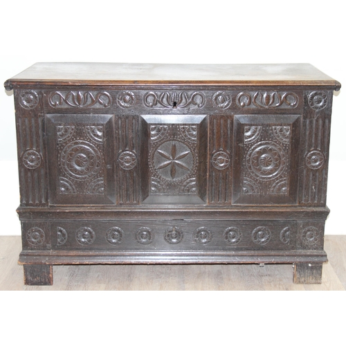 20 - An 18th century carved oak coffer, the carvings depicting geometric roundels and stylised floral car... 