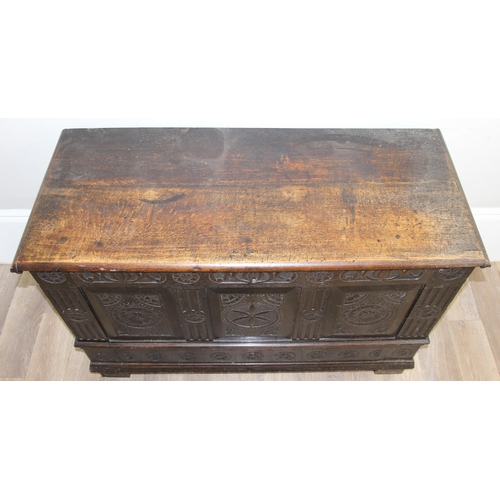 20 - An 18th century carved oak coffer, the carvings depicting geometric roundels and stylised floral car... 