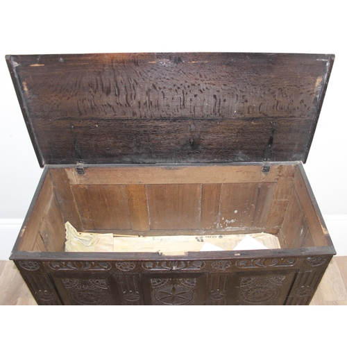 20 - An 18th century carved oak coffer, the carvings depicting geometric roundels and stylised floral car... 