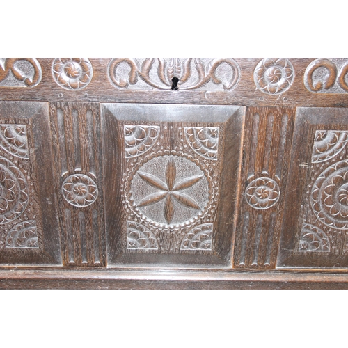 20 - An 18th century carved oak coffer, the carvings depicting geometric roundels and stylised floral car... 