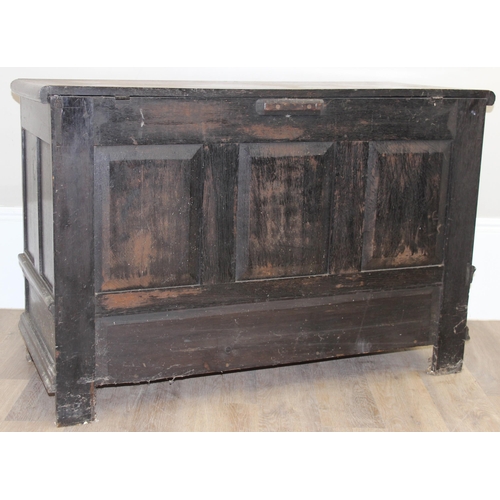 20 - An 18th century carved oak coffer, the carvings depicting geometric roundels and stylised floral car... 