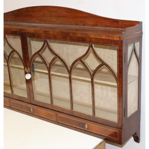 64 - An unusual antique mahogany wall-mountable Gothic style glazed cabinet with three drawers and inlaid... 