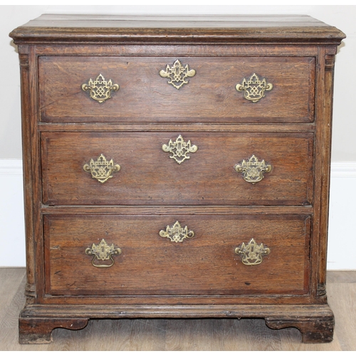 14 - A Georgian Oak chest of drawers with 3 drawers and bracket feet, the drawers with decorative brass f... 