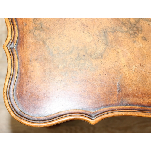 152 - A William & Mary style low table with quarter cut burr walnut veneer, X-form stretcher with piecrust... 