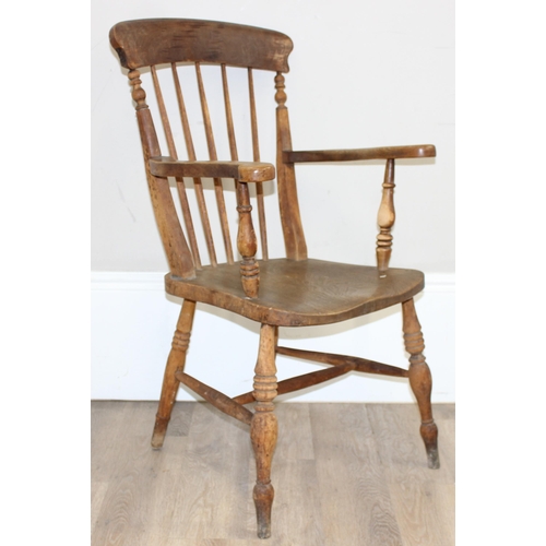 71 - An antique elm seated farmhouse Windsor armchair with stick back, approx 56cm wide x 100cm tall