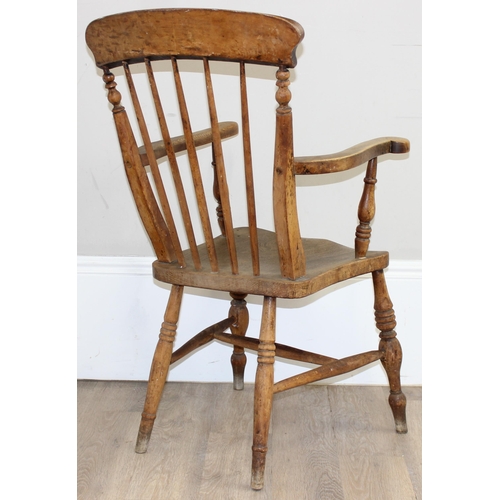 71 - An antique elm seated farmhouse Windsor armchair with stick back, approx 56cm wide x 100cm tall