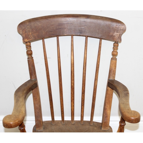 71 - An antique elm seated farmhouse Windsor armchair with stick back, approx 56cm wide x 100cm tall