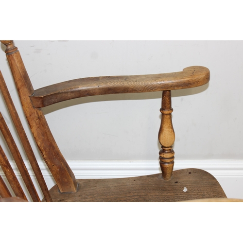 71 - An antique elm seated farmhouse Windsor armchair with stick back, approx 56cm wide x 100cm tall