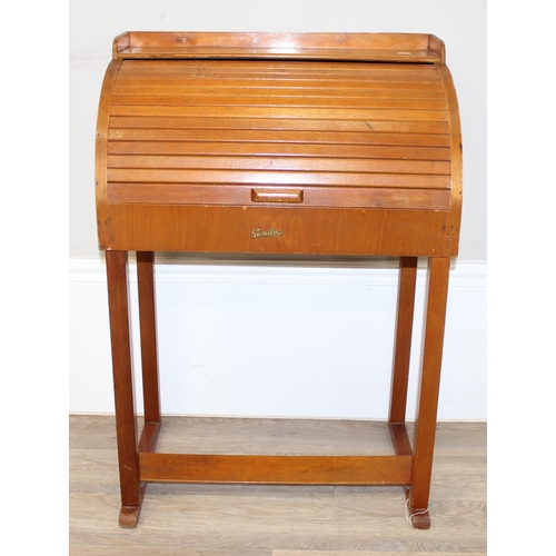 131 - A vintage wooden children's roll top desk by Swallow and a similar small chair, the desk approx 56cm... 