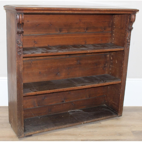 73 - An antique oak bookcase with 3 adjustable shelves and carved strapwork details, approx 122cm wide x ... 