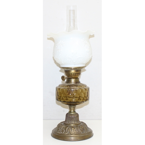 264 - 2 Antique oil lamps with milk glass shades, a glass reservoir, one with cast iron base and the other... 