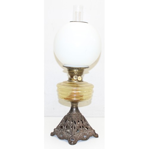 264 - 2 Antique oil lamps with milk glass shades, a glass reservoir, one with cast iron base and the other... 