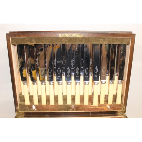 1099S - An extensive 12 person setting silver plated canteen of cutlery, in Art Deco period walnut case, the... 