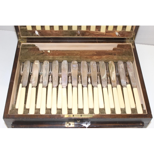 1099S - An extensive 12 person setting silver plated canteen of cutlery, in Art Deco period walnut case, the... 