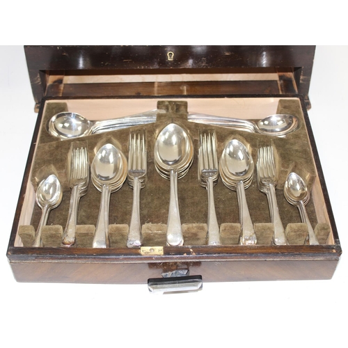 1099S - An extensive 12 person setting silver plated canteen of cutlery, in Art Deco period walnut case, the... 