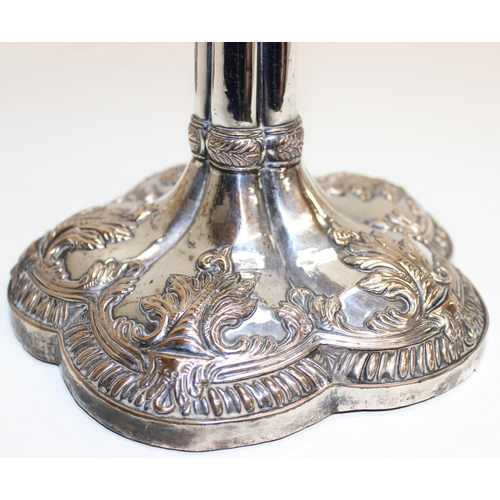 1066 - A pair of mid-18th century style silver plated candlesticks decorated with embossed acanthus scrolls... 