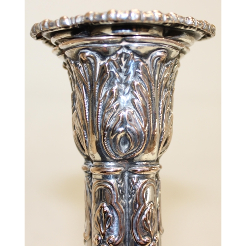 1066 - A pair of mid-18th century style silver plated candlesticks decorated with embossed acanthus scrolls... 