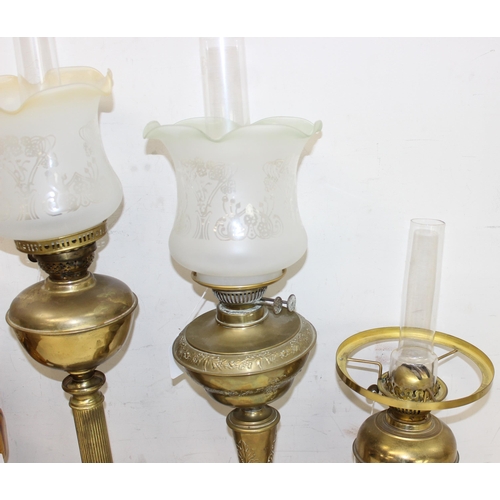 265 - 4 various oil lamps to include 2 with acid etched art nouveau glass shades, and 2 further spare glas... 