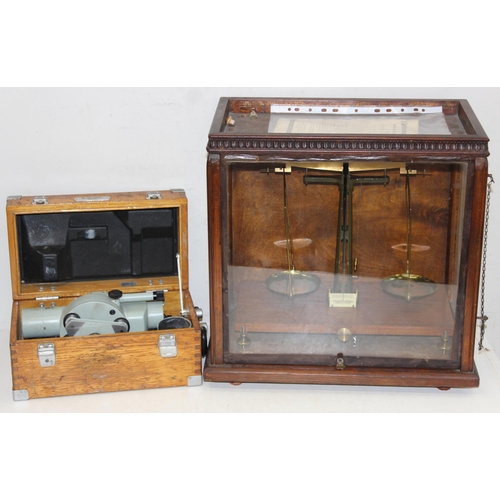 745 - Vintage scientific balance scales in glazed wooden case, approx 48cm x 27cm x 46cm and a surveyors l... 