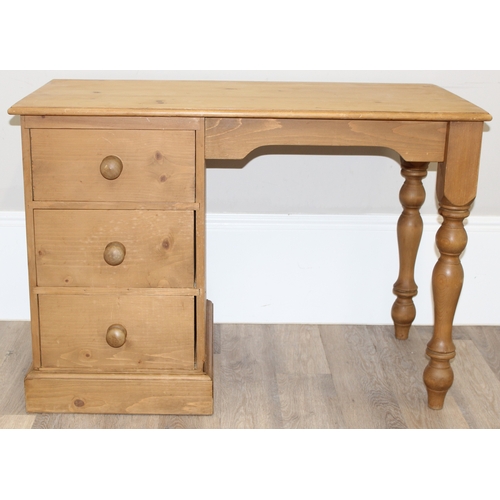 86 - A modern stripped pine desk with 3 drawers, approx 110cm wide x 57cm deep x 77cm tall