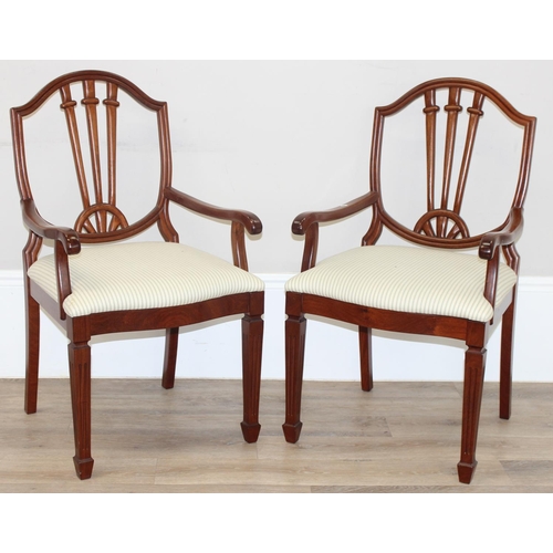 34 - A pair of 20th century hardwood armchairs, believed to be from Hong Kong, with carved shield shaped ... 