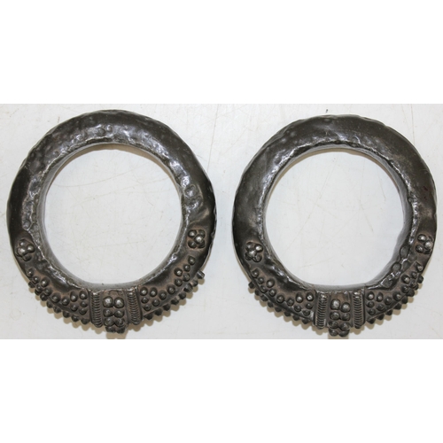 1132 - A pair of unusual ethnic bangles, possibly currency bangles, bronzed finish but XRF testing as appro... 