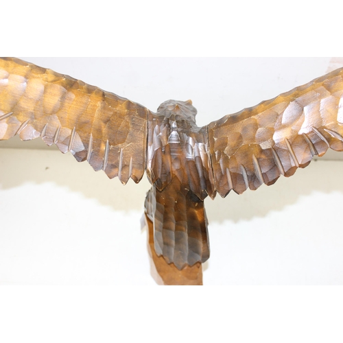 284 - Vintage chip carved wooden model of an eagle perched on a stump with detachable, approx 77cm W x 55c... 