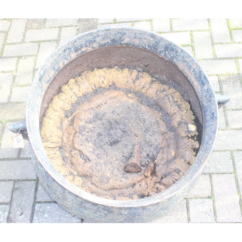 304 - A large cast iron cauldron with 3 legs and small angled handles, possibly by Coalbrookdale but seemi... 