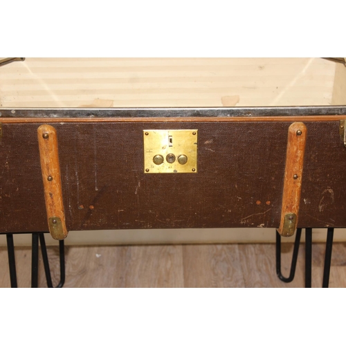 147 - A vintage canvas suitcase or shipping trunk coffee table on metal hairpin legs, approx 77cm wide x 4... 