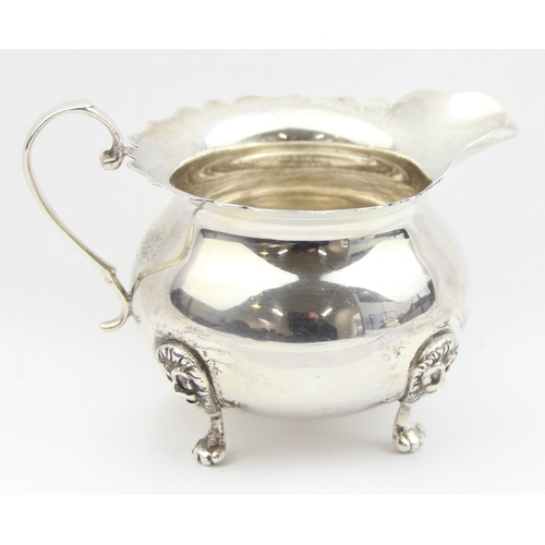 1009D - A vintage silver cream jug with frilled edges, lion mask and paw handles, marked Sterling and XRF co... 