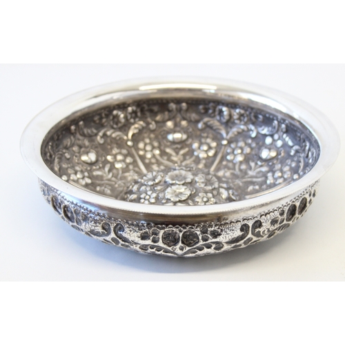 1009A - An impressive embossed Indian or middle eastern silver bowl with raised domed centre, decorated with... 